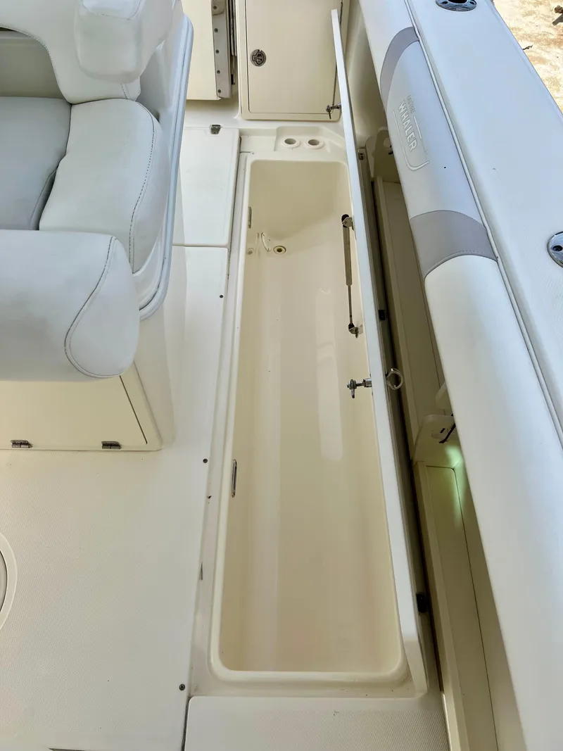 Slide: The Image of 2015 Boston Whaler 250 Outrage boat interior storage compartment. - 32
