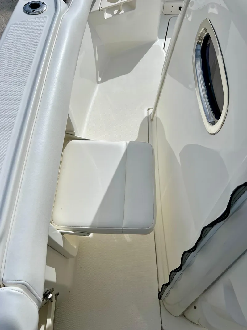 Slide: The Image of 2015 Boston Whaler 250 Outrage boat interior with white seating. - 35