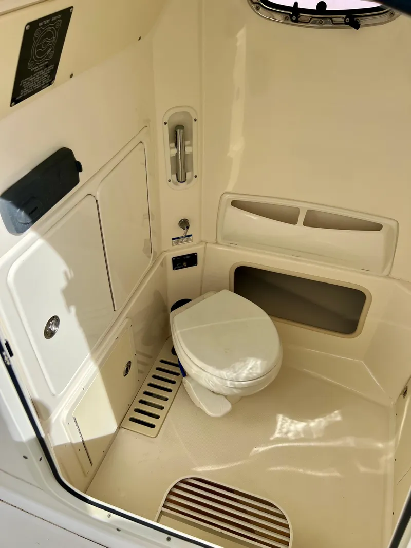 Slide: The Image of 2015 Boston Whaler 250 Outrage boat interior bathroom with toilet. - 39