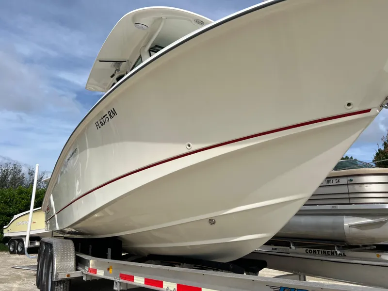 Slide: The Image of 2015 Boston Whaler 250 Outrage boat on a trailer, side view. - 4