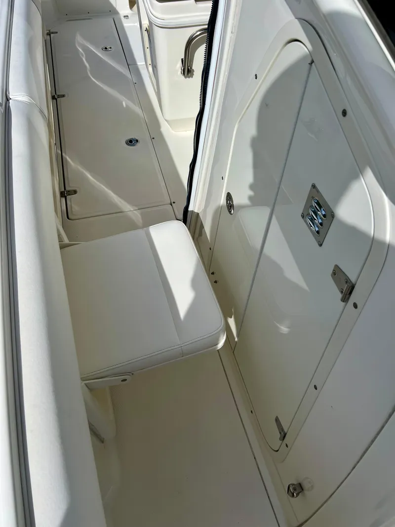 Slide: The Image of 2015 Boston Whaler 250 Outrage interior seating and storage area. - 42