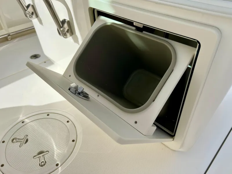 Slide: The Image of Open storage compartment on a 2015 Boston Whaler 250 Outrage boat. - 45