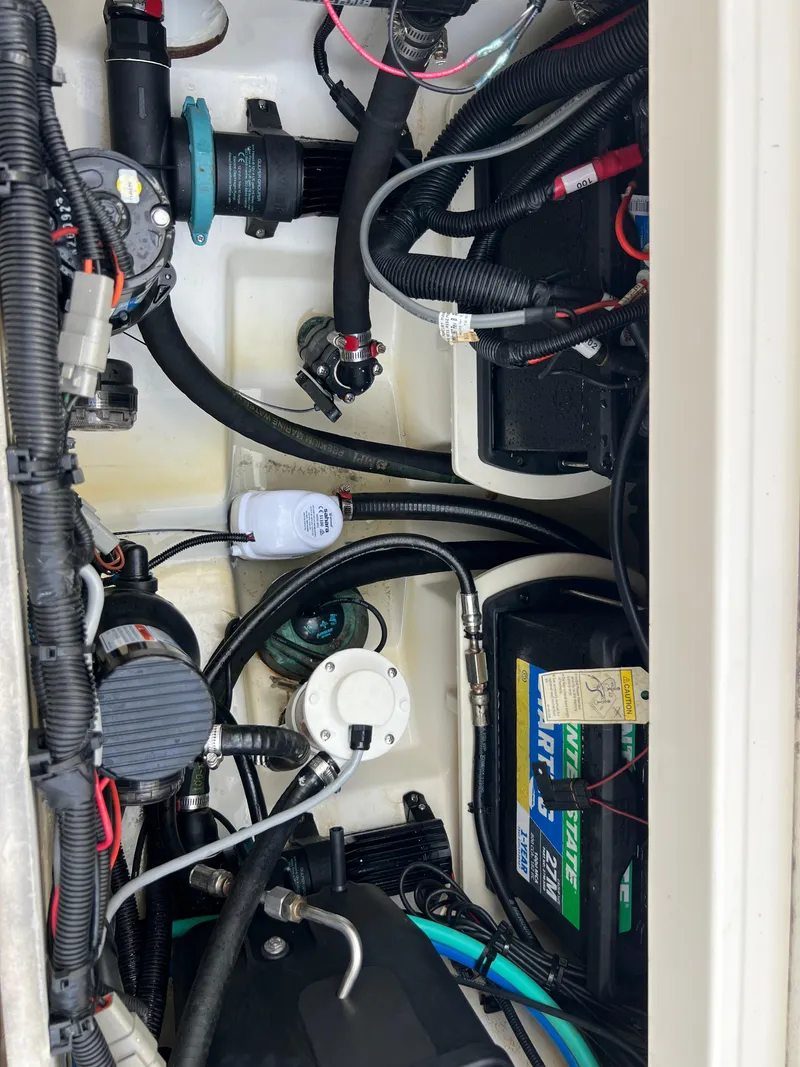 Slide: The Image of 2015 Boston Whaler 250 Outrage engine compartment with wiring and battery. - 48