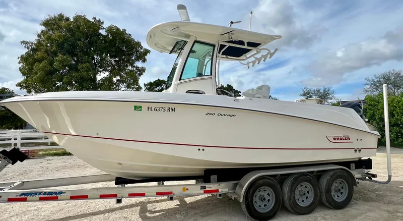 Slide: The Image of 2015 Boston Whaler 250 Outrage boat on a trailer, side view. - 5