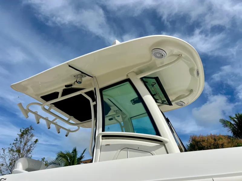 Slide: The Image of 2015 Boston Whaler 250 Outrage boat with hardtop against a blue sky. - 6