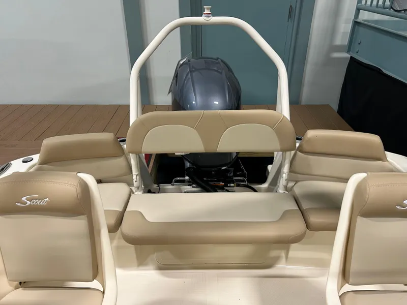 Slide: The Image of 2024 Scout 195 Dorado boat interior with beige seating and outboard motor. - 4
