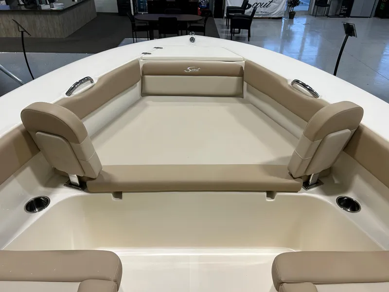 Slide: The Image of 2024 Scout 195 Dorado boat interior with beige seating and stainless steel cup holders. - 6