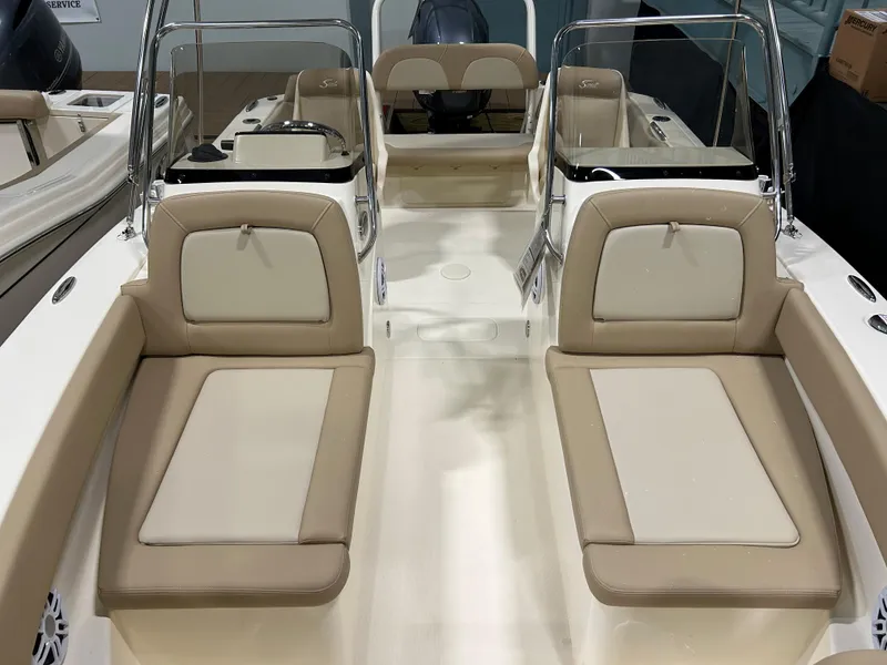 Slide: The Image of 2024 Scout 195 Dorado boat interior with beige seating and dual consoles. - 7