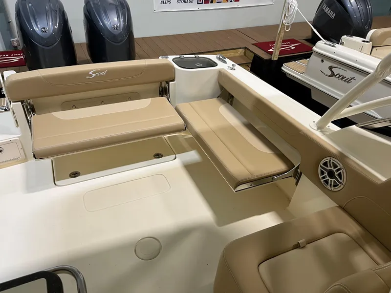 Slide: The Image of 2024 Scout 255 Dorado boat interior with beige seating and dual outboard motors. - 4