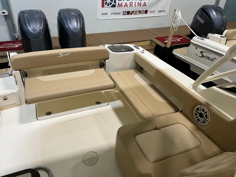 Slide: The Image of 2024 Scout 255 Dorado boat interior with beige seating and dual Yamaha engines. - 5