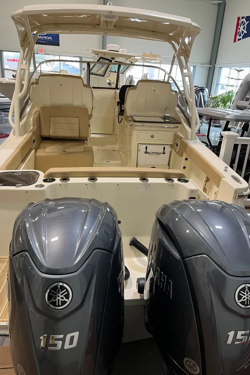 Slide: The Image of 2024 Scout 255 Dorado boat with dual Yamaha 150 engines in showroom. - 7