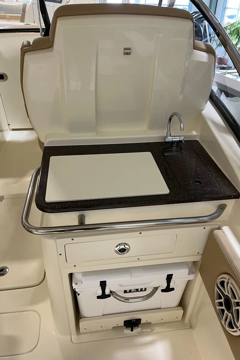 Slide: The Image of 2024 Scout 255 Dorado boat interior with sink and storage. - 8