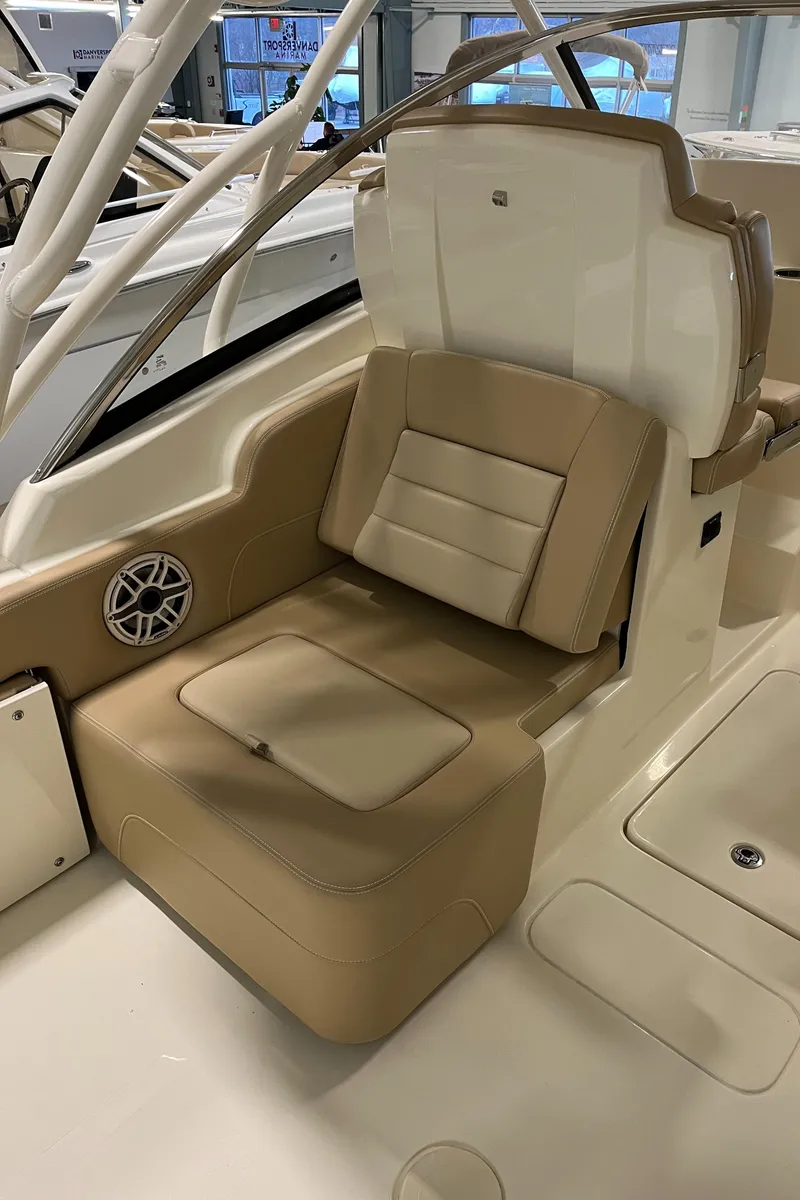 Slide: The Image of 2024 Scout 255 Dorado boat interior with tan seating and built-in speaker. - 9