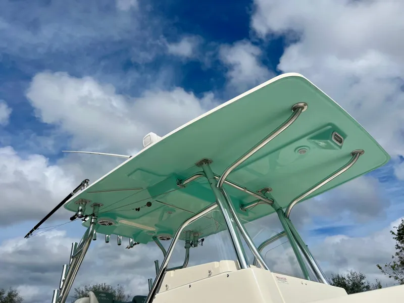 Slide: The Image of 2014 Cobia 296 Center Console boat with T-top against a cloudy sky. - 10