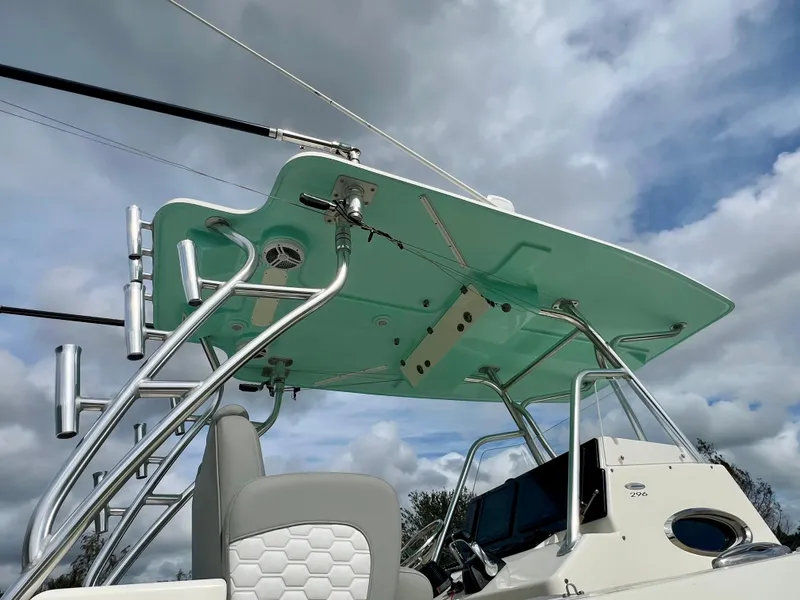 Slide: The Image of 2014 Cobia 296 Center Console boat with T-top and rod holders. - 11