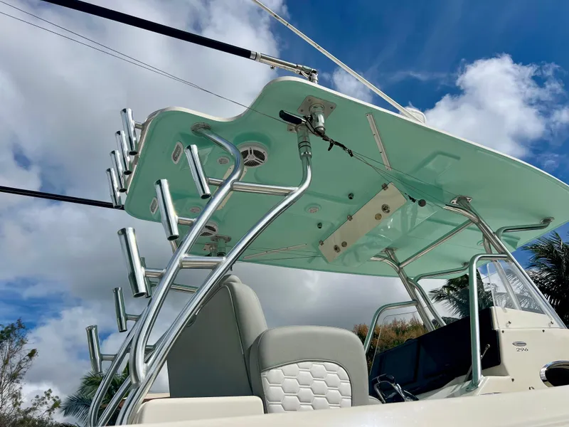Slide: The Image of 2014 Cobia 296 Center Console boat with T-top and rod holders. - 12