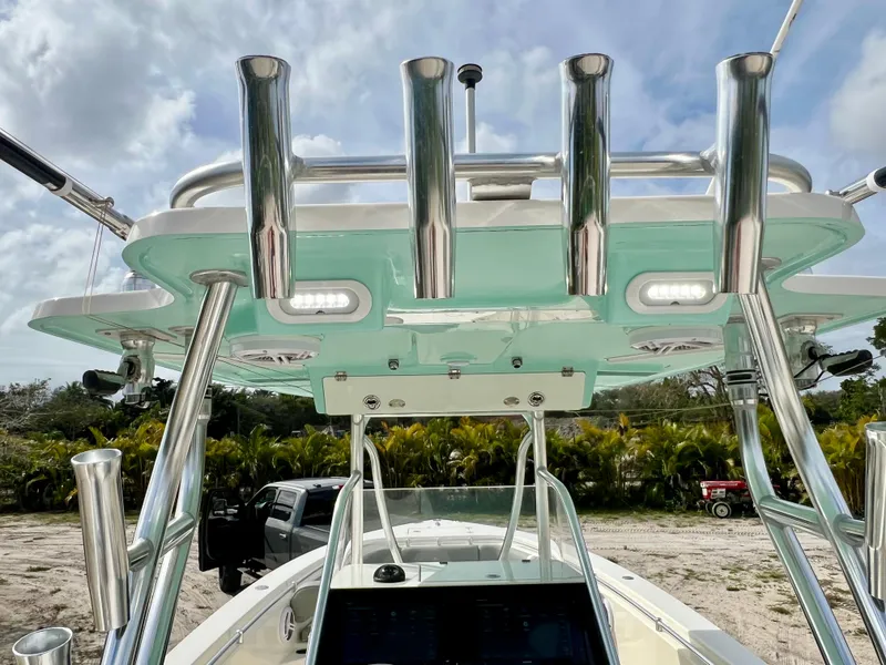 Slide: The Image of 2014 Cobia 296 Center Console boat with rod holders and canopy. - 13