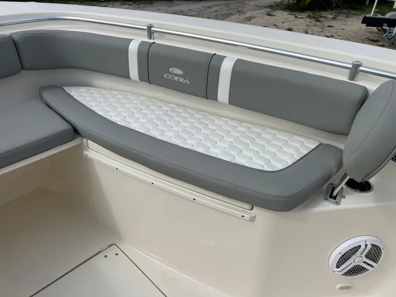 Slide: The Image of 2014 Cobia 296 Center Console boat with cushioned seating and speaker. - 16