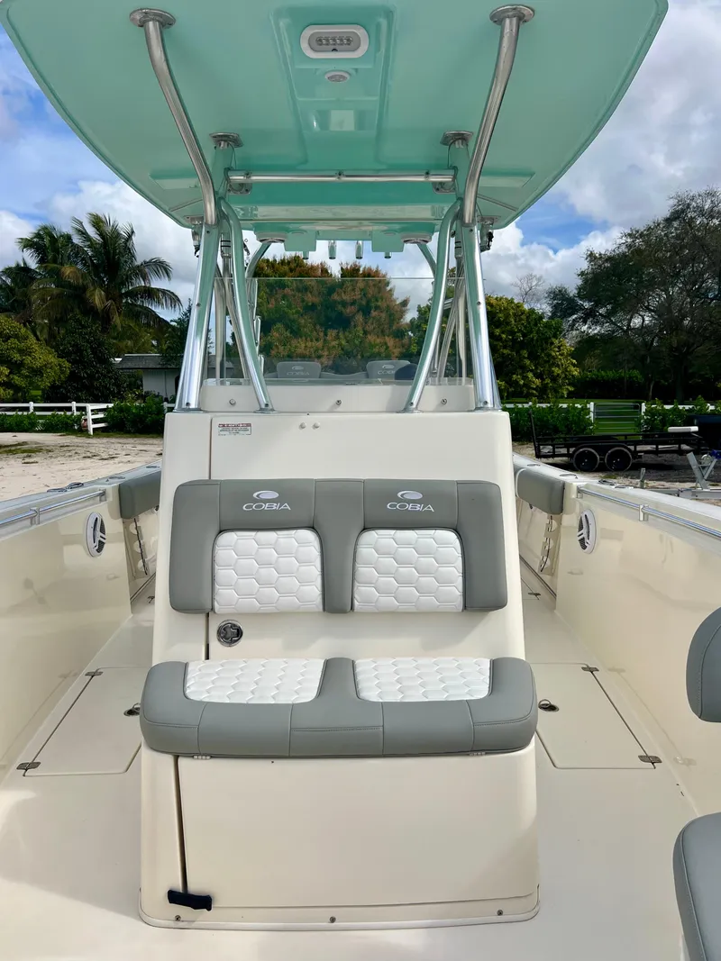 Slide: The Image of 2014 Cobia 296 Center Console boat with dual seating and T-top. - 18
