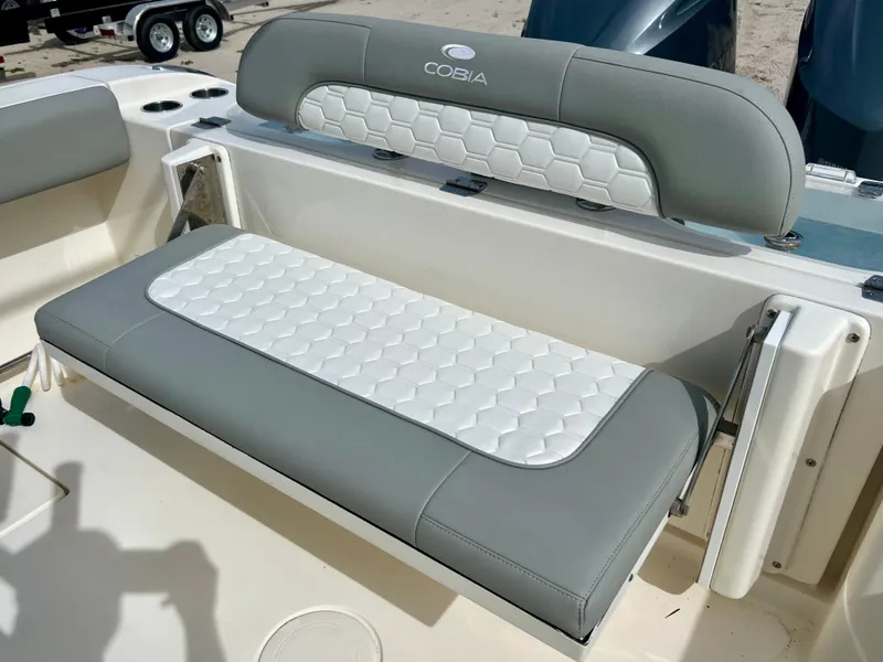 Slide: The Image of 2014 Cobia 296 Center Console boat with cushioned seating. - 19