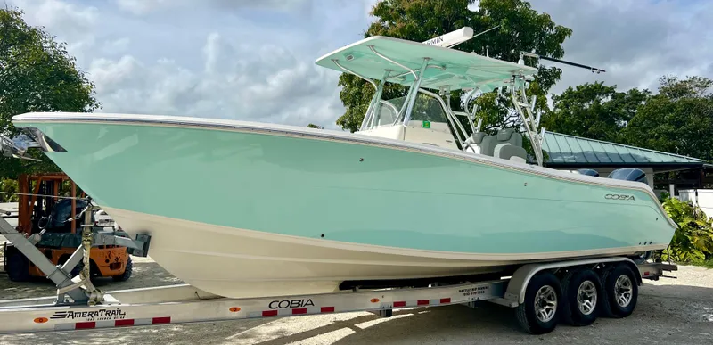 Slide: The Image of 2014 Cobia 296 Center Console boat on a trailer. - 2