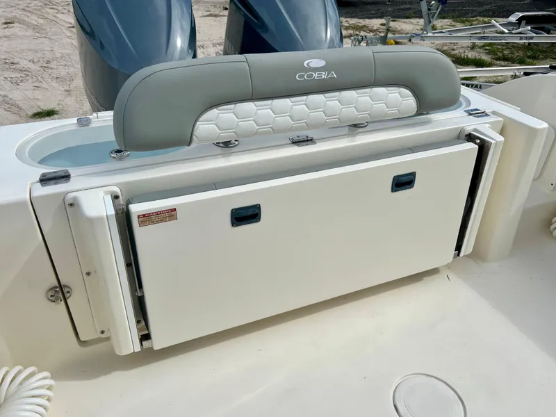 Slide: The Image of 2014 Cobia 296 Center Console boat with foldable seating and storage. - 22