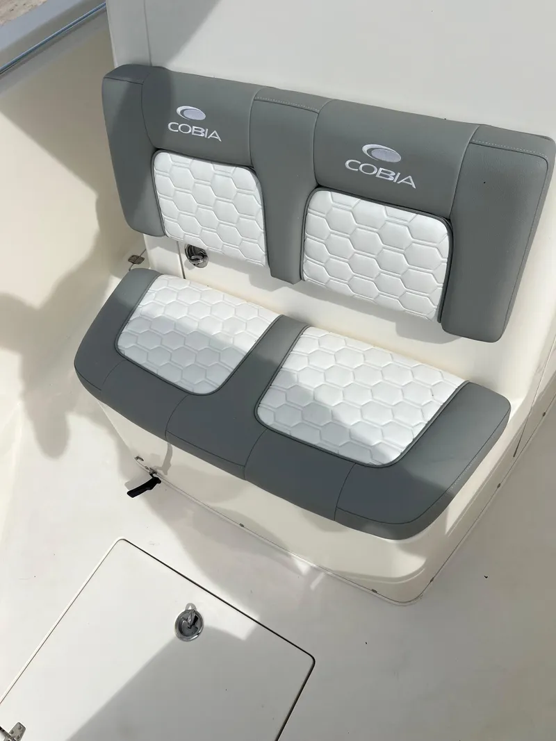 Slide: The Image of 2014 Cobia 296 Center Console boat with cushioned seating. - 24