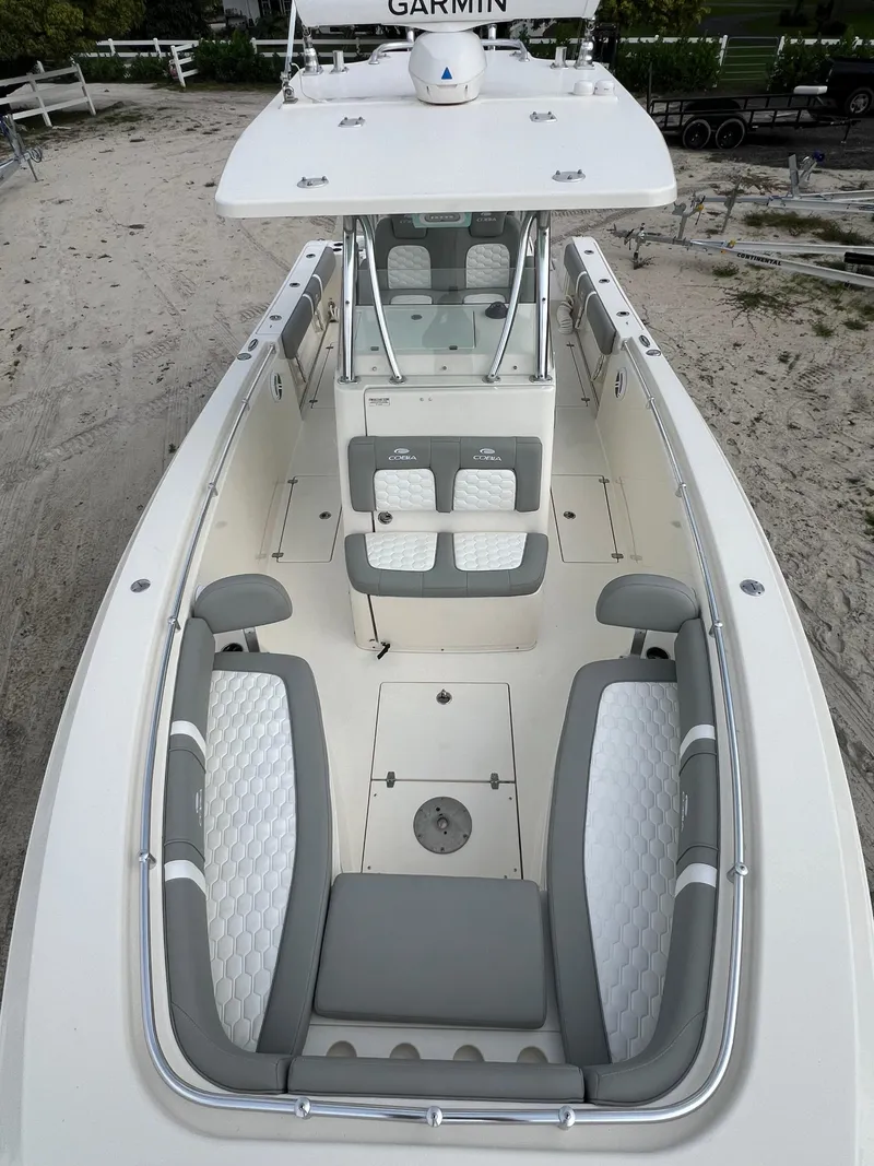 Slide: The Image of 2014 Cobia 296 Center Console boat with spacious seating and Garmin electronics. - 26