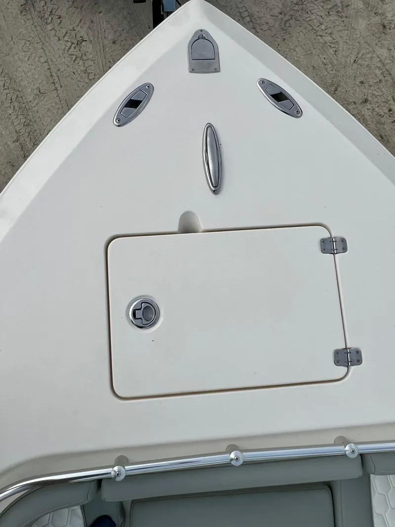 Slide: The Image of 2014 Cobia 296 Center Console boat bow with storage hatch. - 27