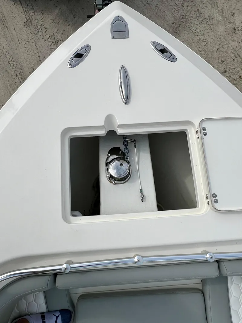 Slide: The Image of 2014 Cobia 296 Center Console boat bow with anchor storage compartment. - 28