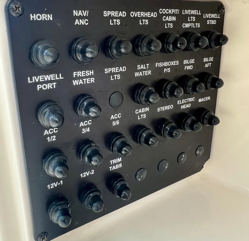 Slide: The Image of Control panel of a 2014 Cobia 296 Center Console boat with labeled switches. - 30