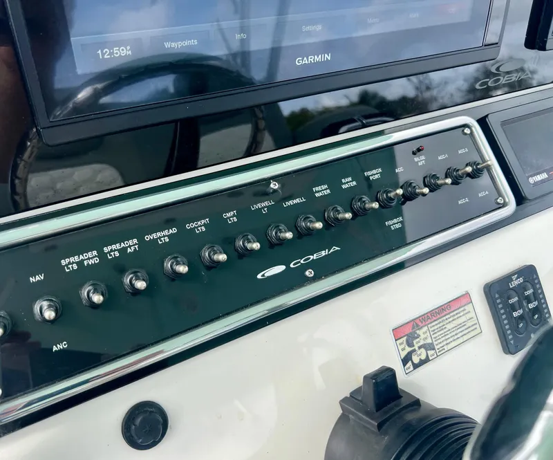 Slide: The Image of Control panel of a 2014 Cobia 296 Center Console boat with Garmin navigation system. - 33