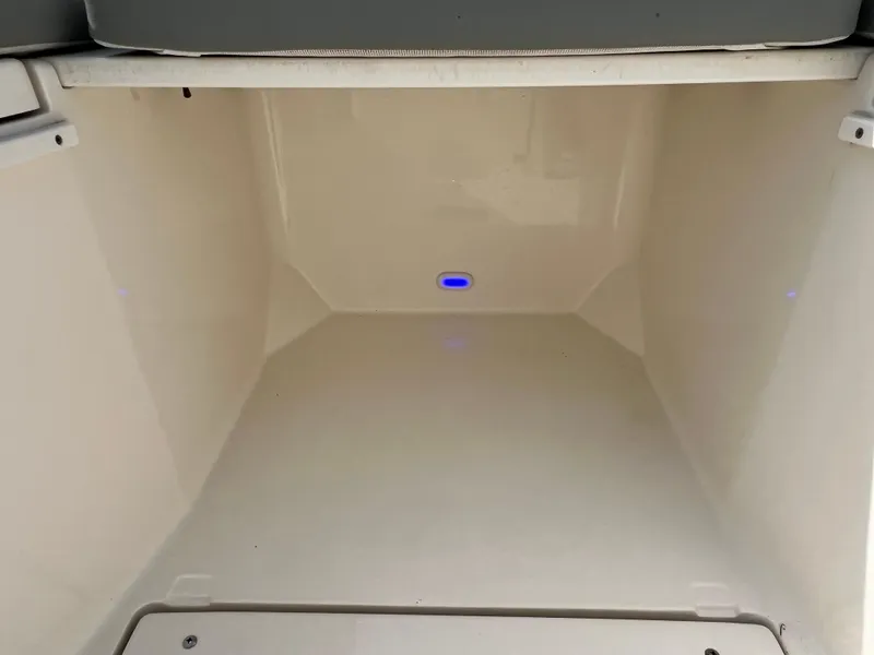 Slide: The Image of 2014 Cobia 296 Center Console storage compartment with interior lighting. - 43