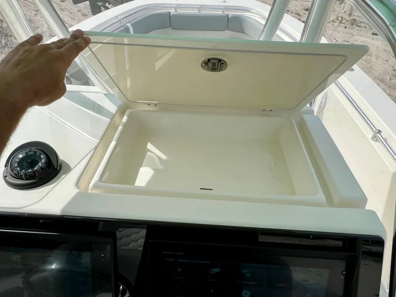 Slide: The Image of 2014 Cobia 296 Center Console storage compartment and navigation instruments. - 46