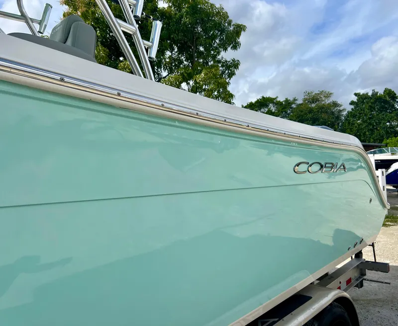 Slide: The Image of 2014 Cobia 296 Center Console boat in light blue on a trailer. - 6