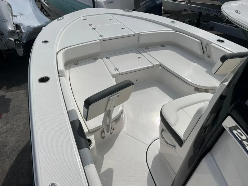 Slide: The Image of 2024 Robalo 246 Cayman boat interior with seating and storage compartments. - 10