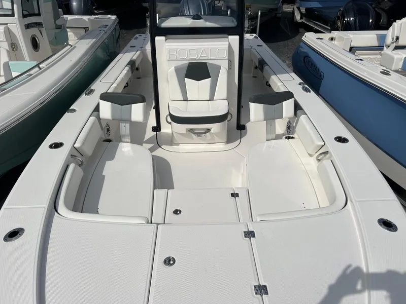 Slide: The Image of 2024 Robalo 246 Cayman boat interior with seating and storage compartments. - 11