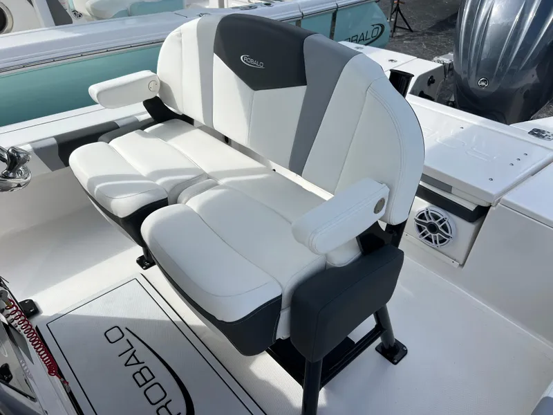 Slide: The Image of 2024 Robalo 246 Cayman boat seating with white and gray upholstery. - 12