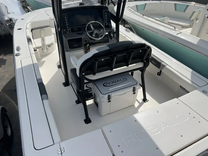 Slide: The Image of 2024 Robalo 246 Cayman boat interior with helm station and seating. - 5