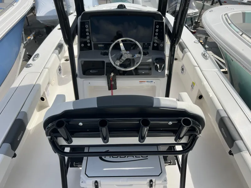 Slide: The Image of 2024 Robalo 246 Cayman boat cockpit with steering wheel and control panel. - 6