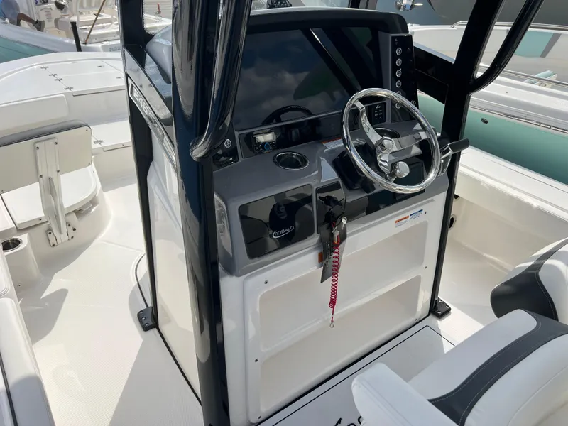 Slide: The Image of 2024 Robalo 246 Cayman boat cockpit with steering wheel and control panel. - 7