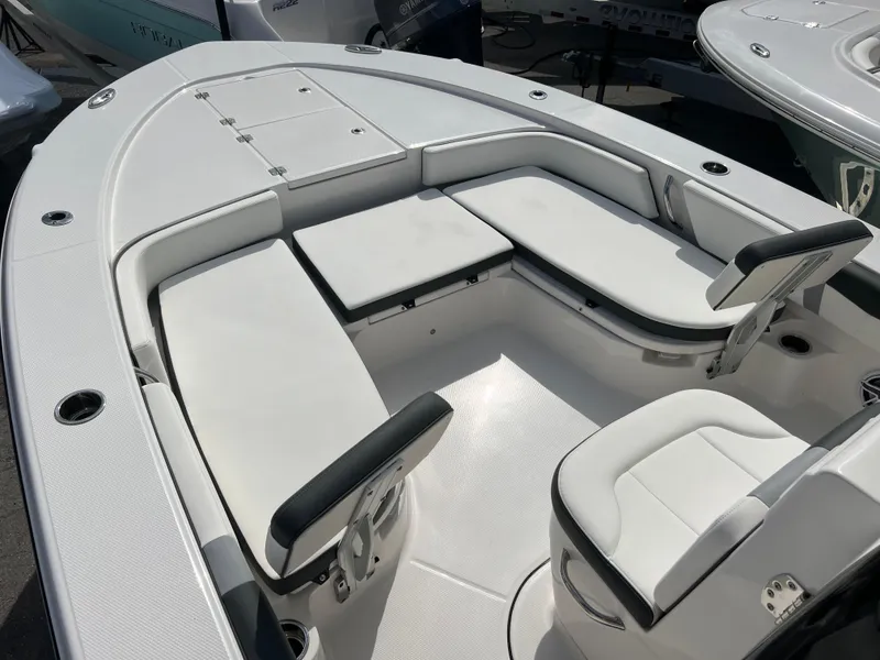 Slide: The Image of 2024 Robalo 246 Cayman boat interior with cushioned seating and storage compartments. - 9