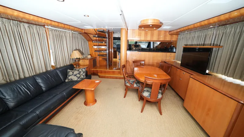 Slide: The Image of Luxurious interior of a 2002 Queenship 70 Baretta yacht with elegant wood finishes. - 11