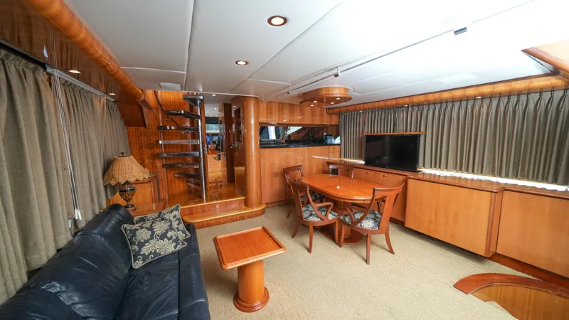 Slide: The Image of Luxurious interior of a 2002 Queenship 70 Baretta yacht with elegant wood finishes. - 12