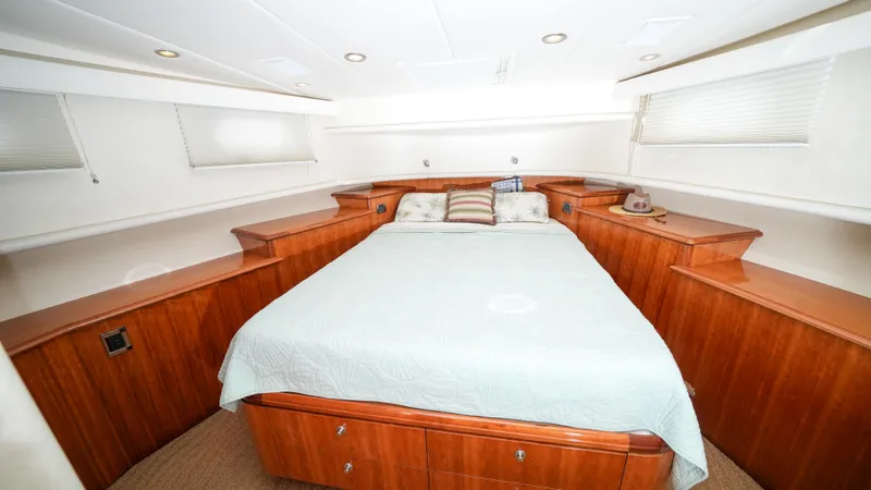 Slide: The Image of Luxurious bedroom interior of 2002 Queenship 70 Baretta yacht with wooden cabinetry. - 14