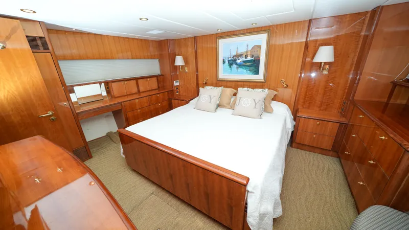 Slide: The Image of Luxurious master bedroom on 2002 Queenship 70 Baretta yacht with wooden furnishings. - 16