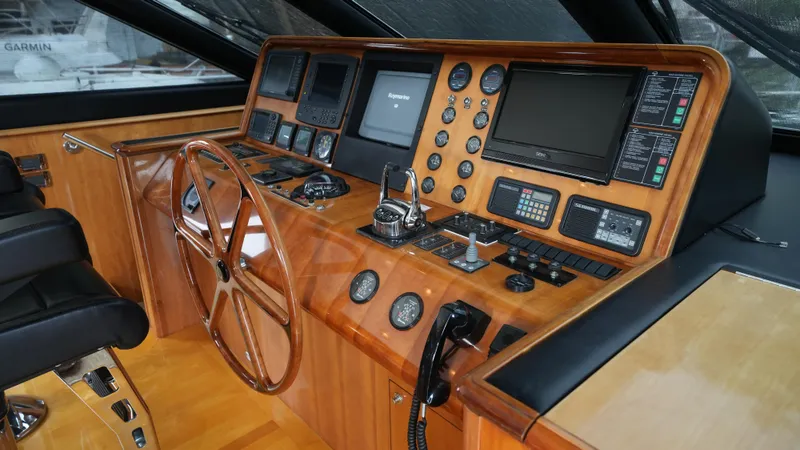 Slide: The Image of Helm station of 2002 Queenship 70 Baretta yacht with wooden dashboard and navigation equipment. - 2