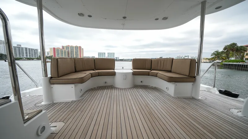 Slide: The Image of Spacious deck seating on a 2002 Queenship 70 Baretta yacht with waterfront views. - 21