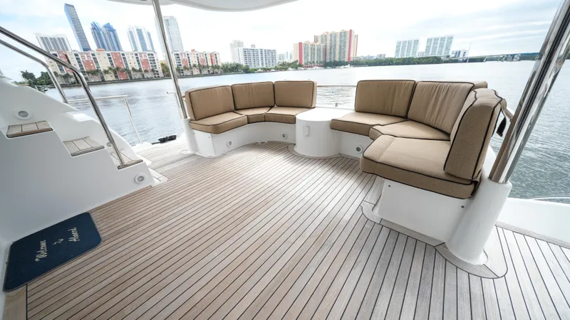 Slide: The Image of Luxurious seating area on a 2002 Queenship 70 Baretta yacht with waterfront city view. - 22