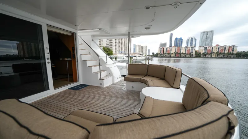 Slide: The Image of Luxury deck of 2002 Queenship 70 Baretta yacht with city skyline view. - 24